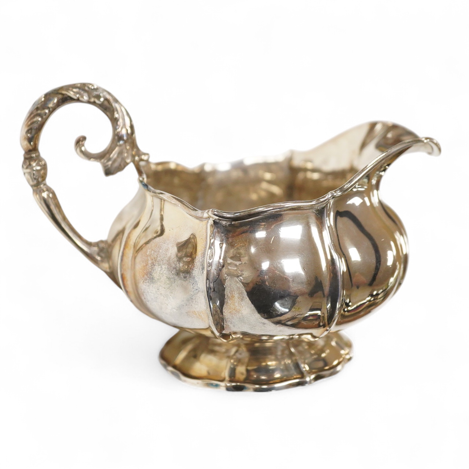 A George IV silver cream jug, with engraved monogram, by William, Charles and Henry Eley, London, 1824, height 10.5cm, 7.7oz.